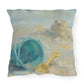 Decorative pillow with a beach-themed design featuring a sandcastle, bucket, and shovel.