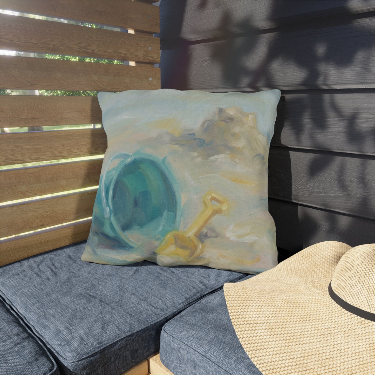 Decorative pillow with a blue and yellow design on a cushioned bench.