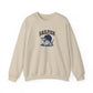 A beige crewneck sweatshirt featuring a graphic of a sailfish jumping from the water with the word 'SAILFISH' printed above it, displayed on a clean white background.