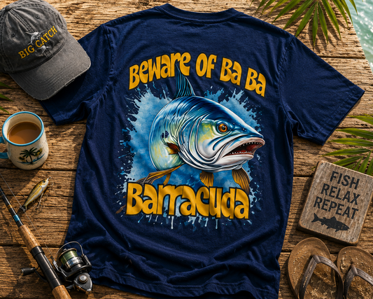 Navy blue t-shirt with fish graphic and text on a wooden surface with fishing gear and accessories.