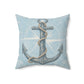 Light blue square decorative pillow with large anchor emblem in rope