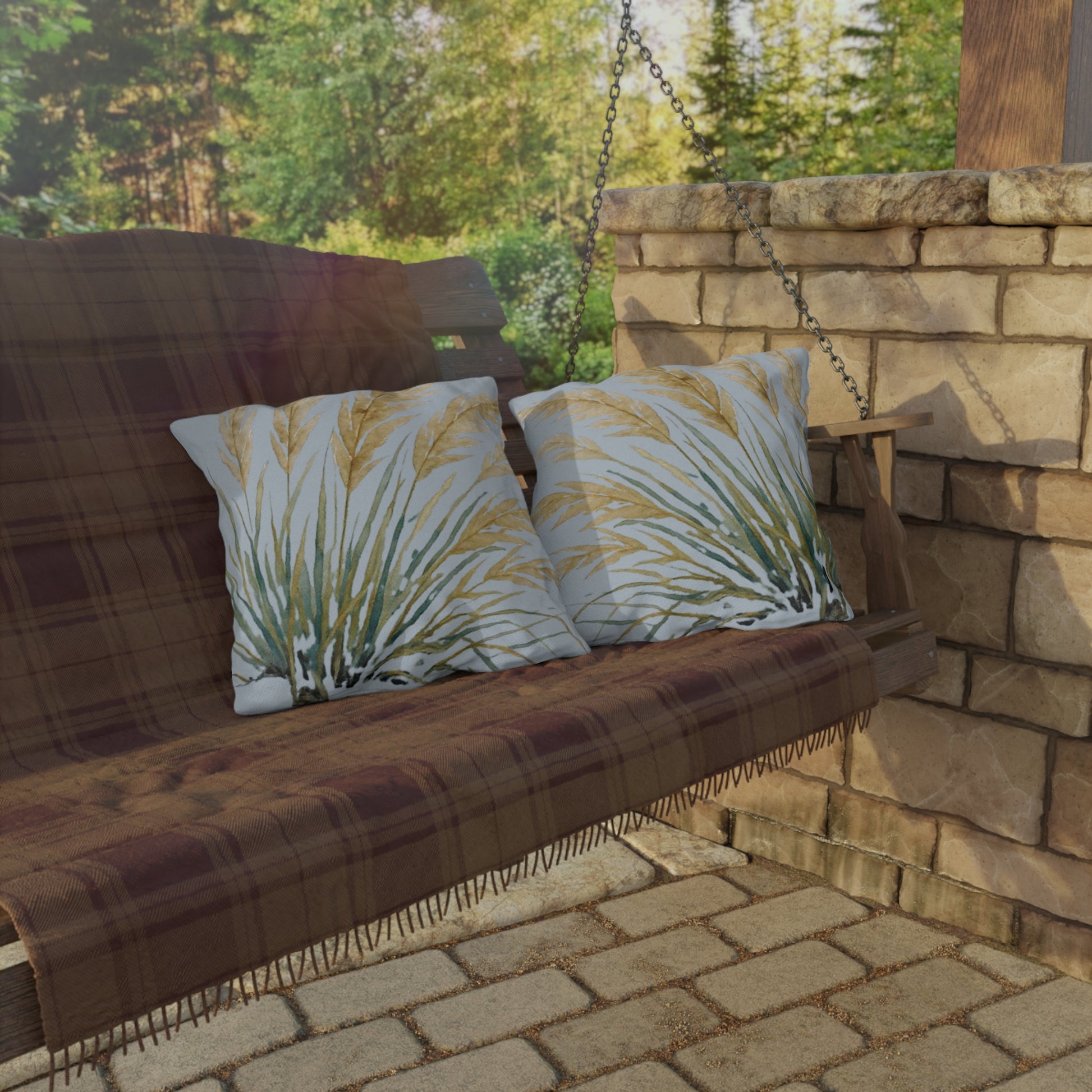 Wooden swing with patterned cushions against a stone wall and greenery background
