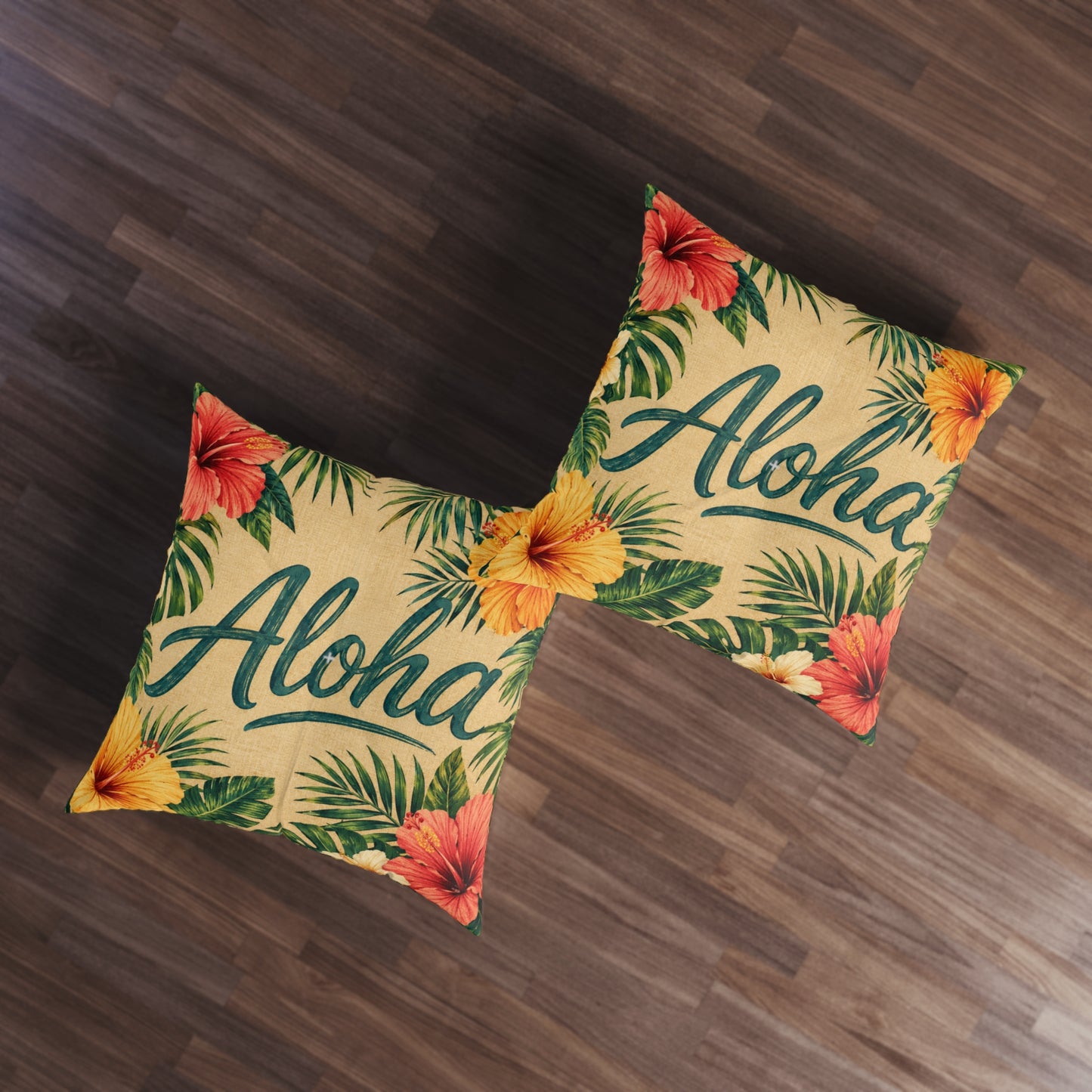 Square tufted floor pillows with Aloha lettering, hibiscus blooms, and palm leaf print on tan