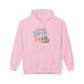 A light pink pullover hoodie with a graphic on the chest that reads 'I need a Beach Day' in teal and coral script, accompanied by illustrations of a beach umbrella, palm tree, and flowers. The hoodie is displayed against a clean white background.