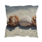 Pillow with a design of seashells on a sandy background