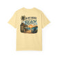 Beige t-shirt with beach graphic and text on a white background