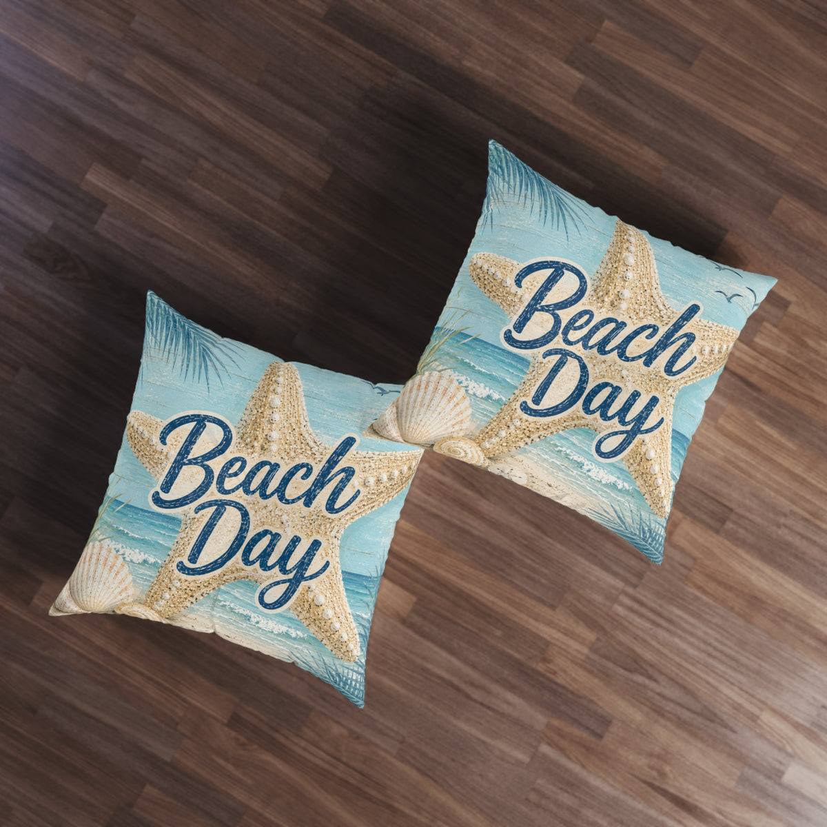 Two square tufted floor pillows, light blue 'Beach Day' starfish and seashell print.
