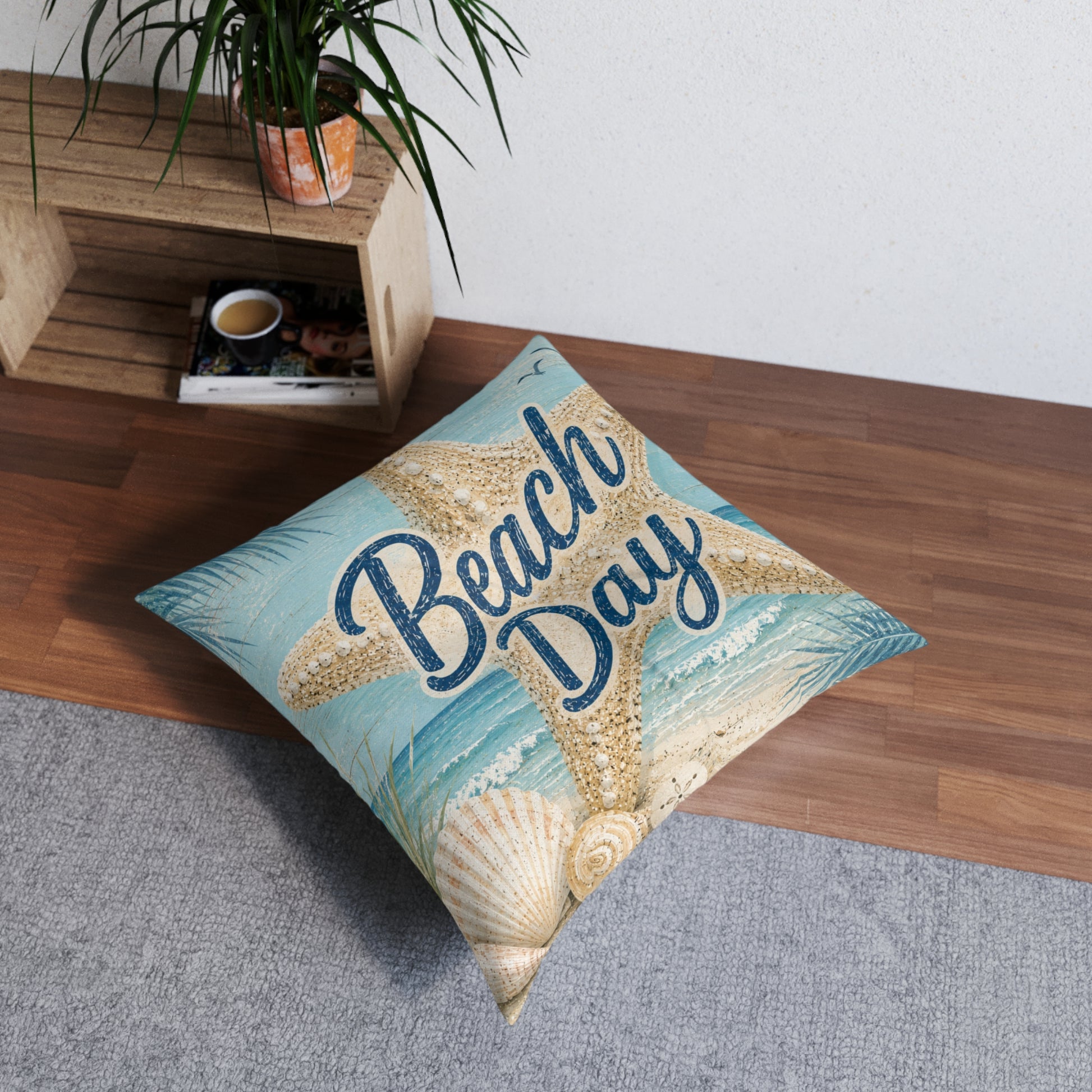 Square tufted floor pillow, light blue 'Beach Day' with seashell and starfish print.