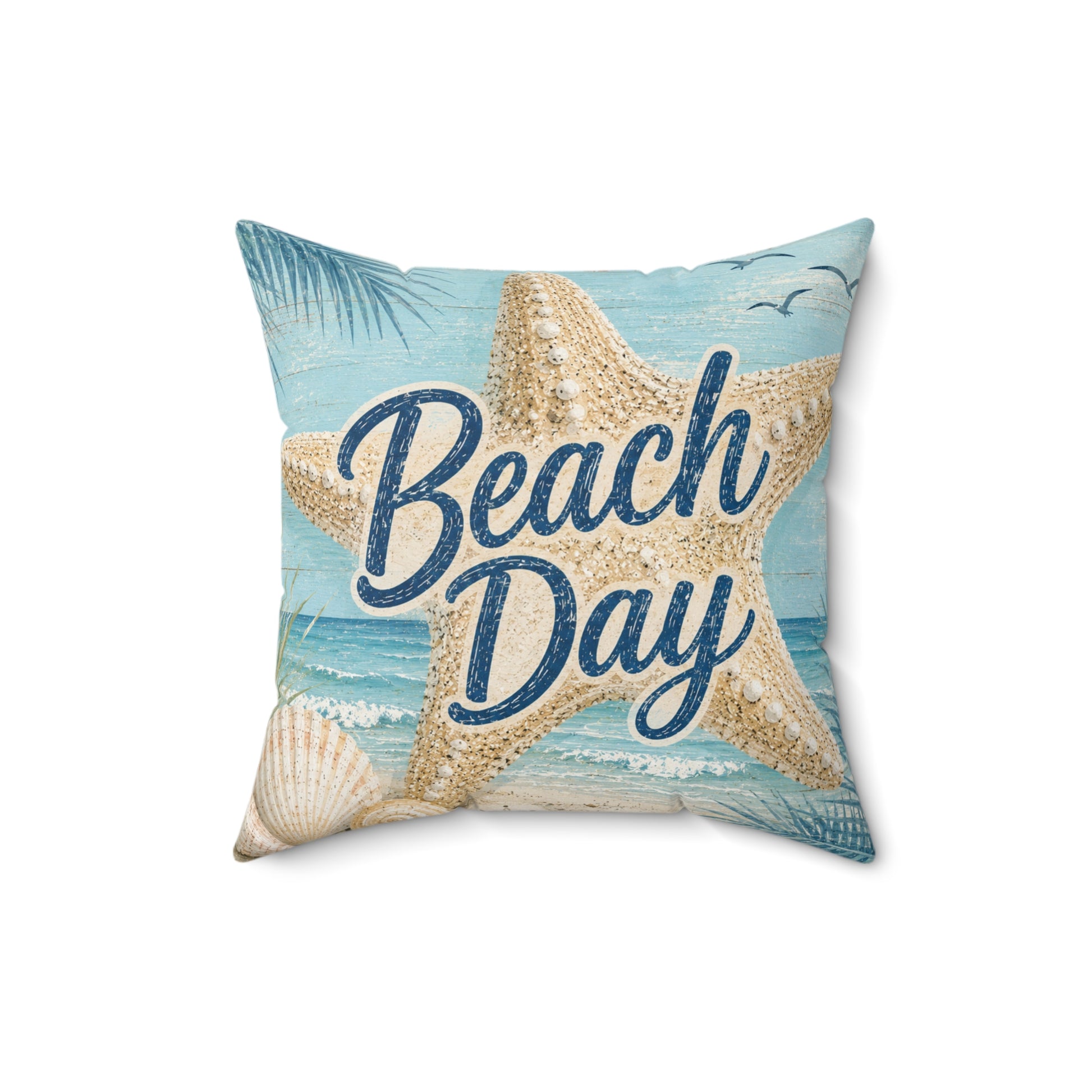 Square beach-themed throw pillow featuring a large beige starfish over a light blue ocean and sky print, with the words “Beach Day” in dark blue script and seashell details.