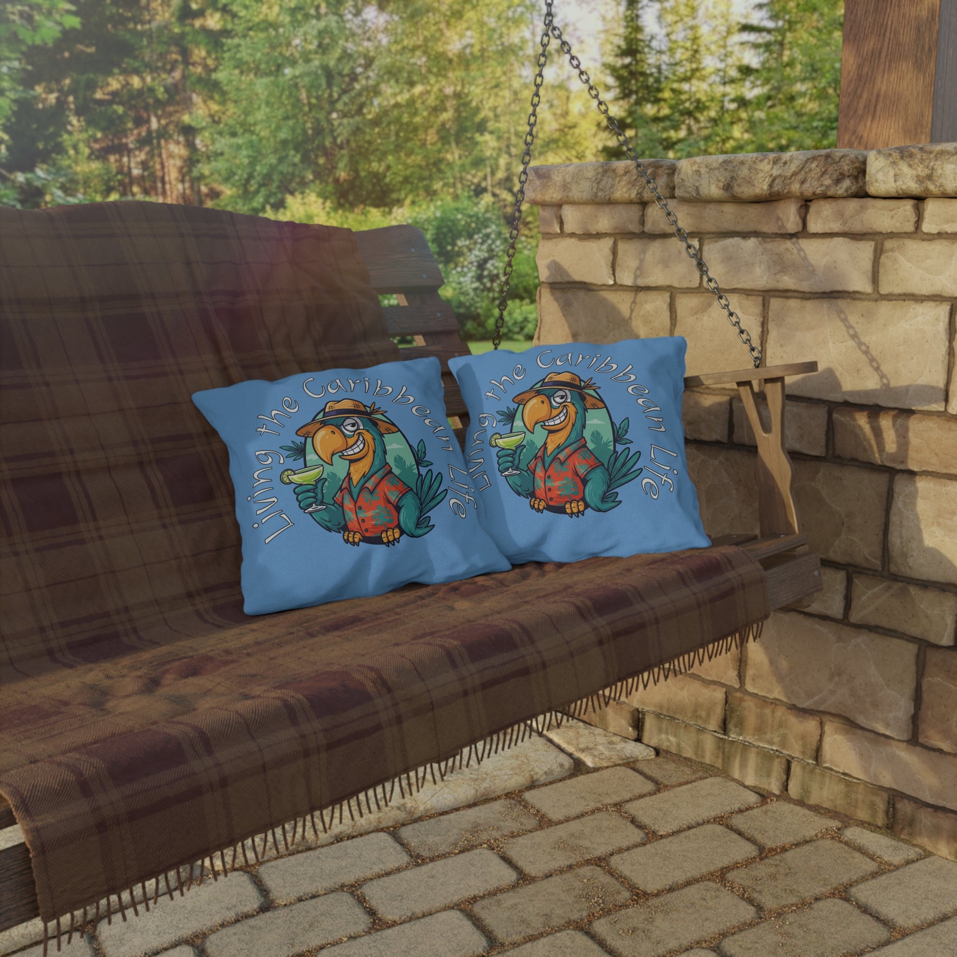 Two blue pillows with a cartoon character on a wooden swing set against a stone wall and greenery.