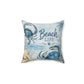 A square decorative throw pillow featuring a blue and beige 'Beach Life' nautical print with crabs and palm leaves on a white background.