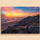 Beach scene with sunset, waves, and sand dunes on a beige background