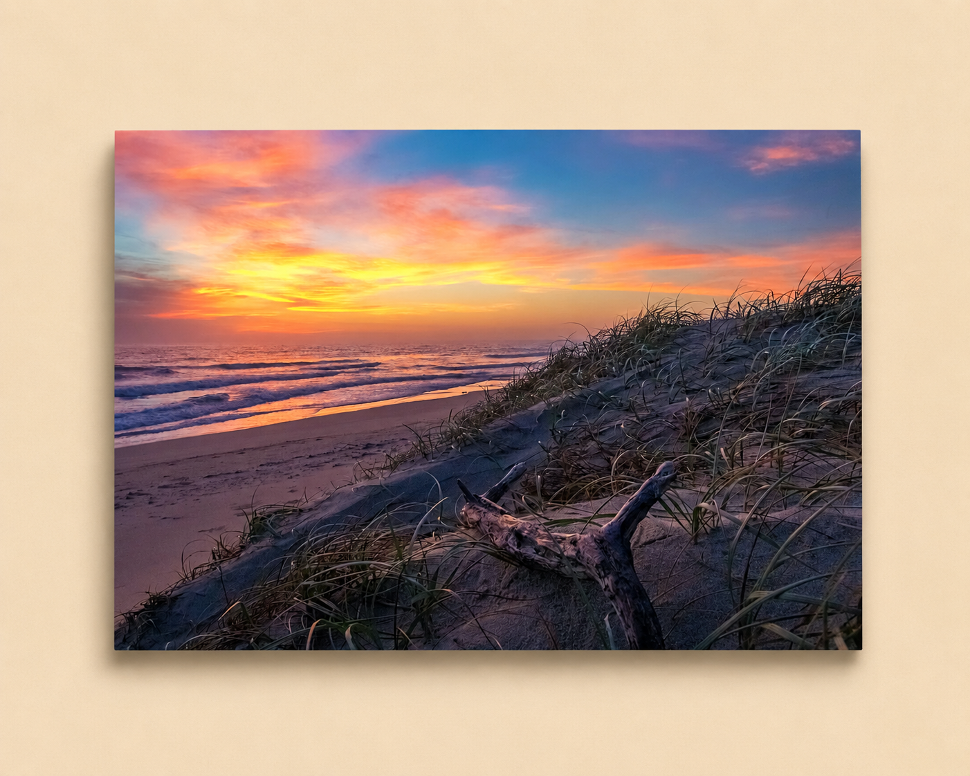 Beach scene with sunset, waves, and sand dunes on a beige background