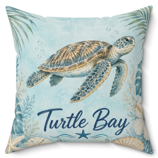 A square decorative throw pillow featuring an illustration of a sea turtle on a light blue background with palm leaves, seashells, and the words 'Turtle Bay' in navy script.