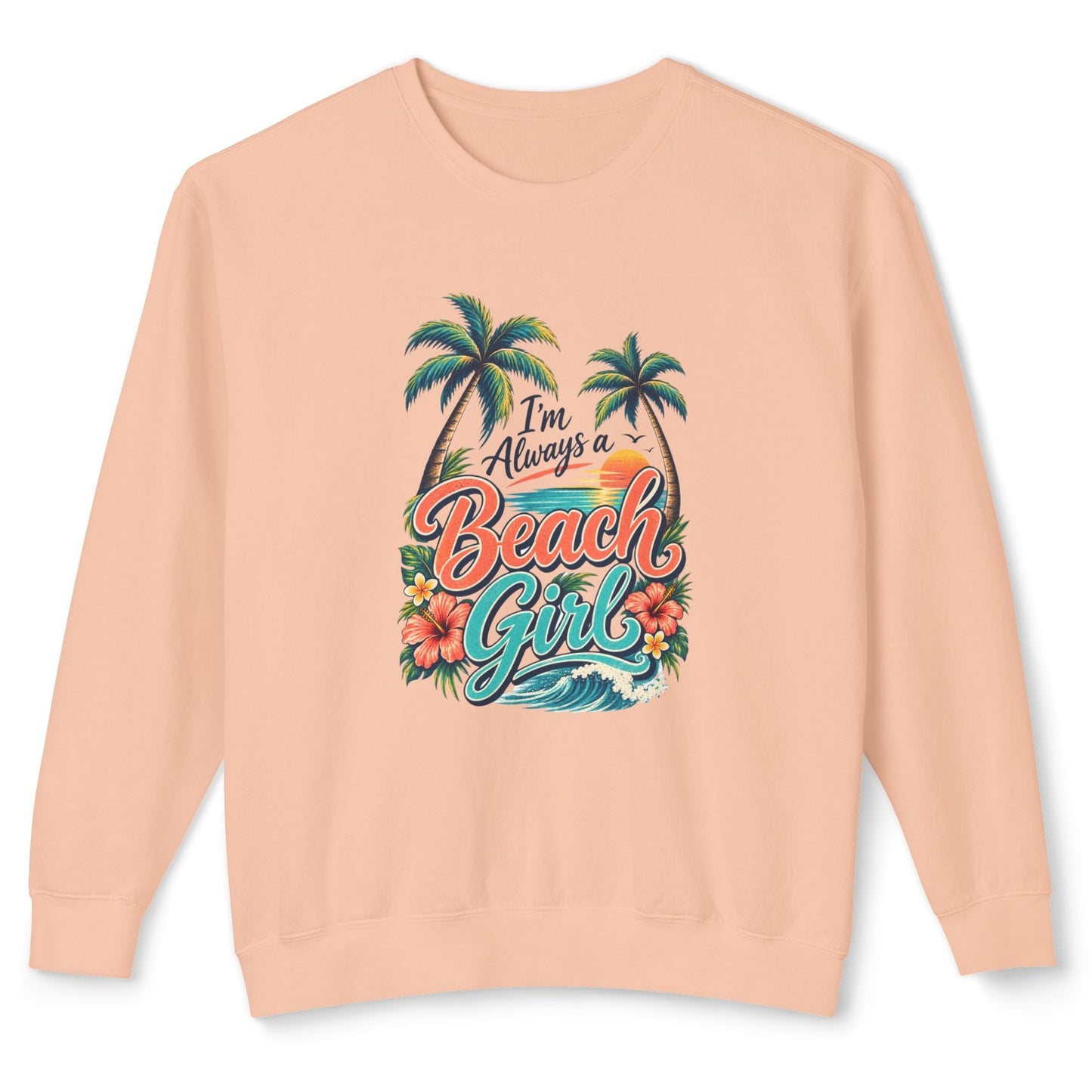 A peach-colored crewneck sweatshirt featuring a colorful graphic on the front with the text 'I'm Always a Beach Girl' in stylized lettering, accompanied by palm trees, hibiscus flowers, and ocean waves.