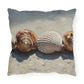 Decorative pillow with shell design on a white background