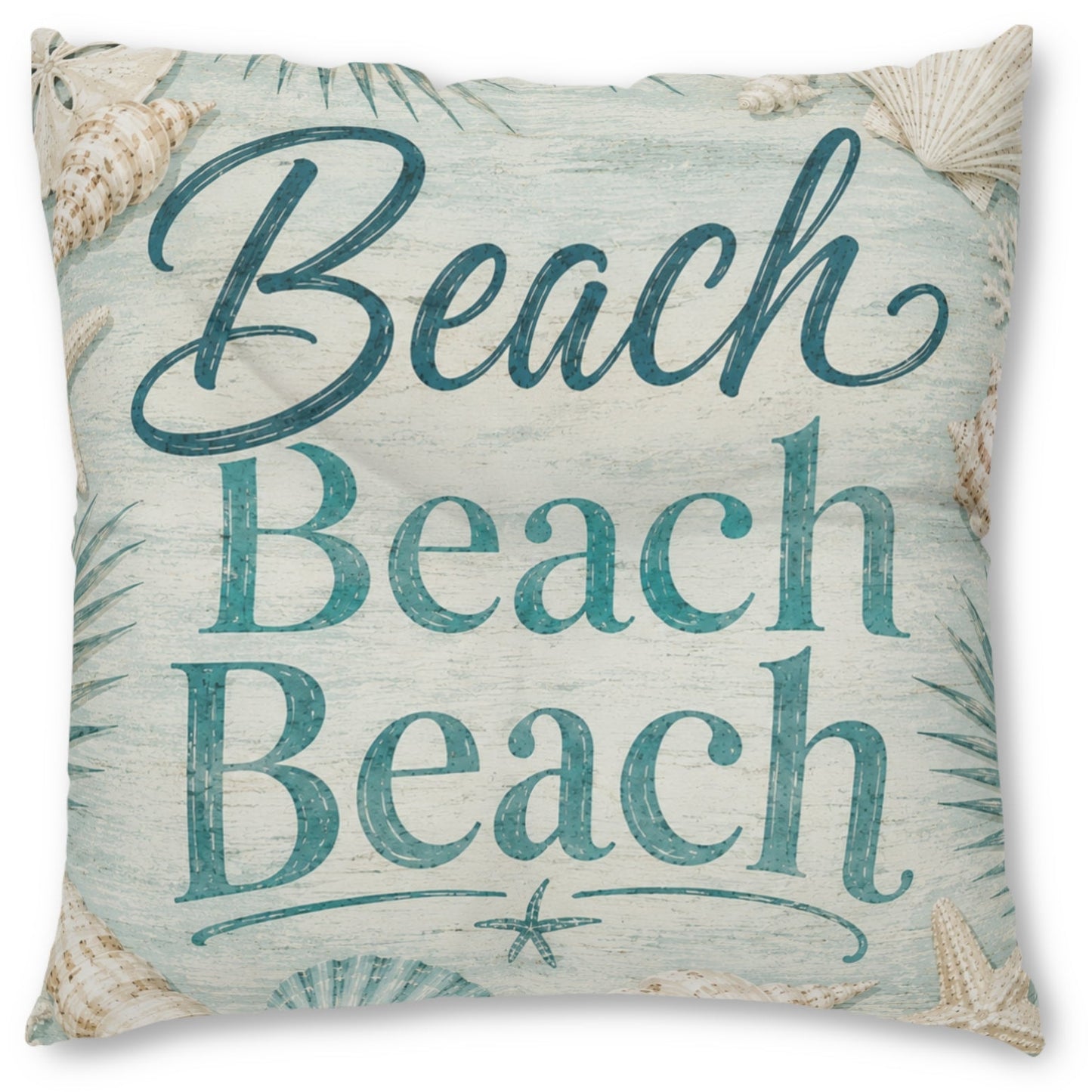A square decorative throw pillow featuring the phrase 'Beach Beach Beach' in teal script and serif lettering on a distressed light blue and off-white background, decorated with seashell and palm leaf motifs.
