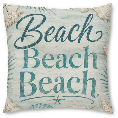 A square decorative throw pillow featuring the phrase 'Beach Beach Beach' in teal script and serif lettering on a distressed light blue and off-white background, decorated with seashell and palm leaf motifs.