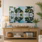 Living room with a large painting of palm trees, a wooden console table, and decorative items.