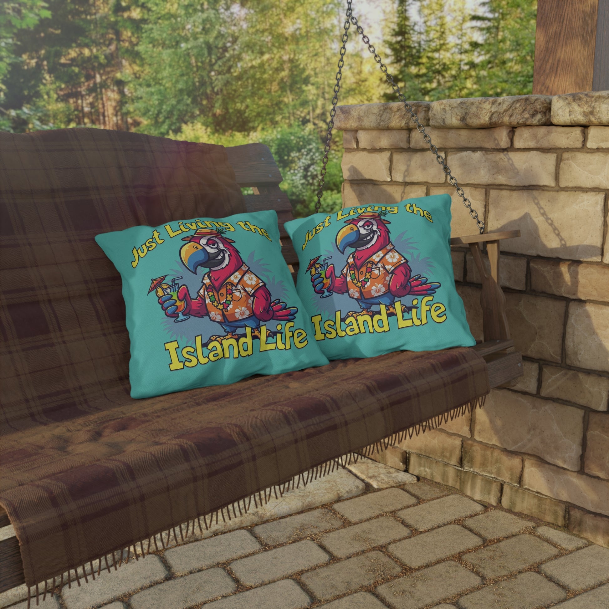 Two colorful pillows with a parrot design and 'Island Life' text on a wooden swing.