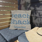 Pillow with 'Beach Shack Caribbean Islands' text on a wooden bench
