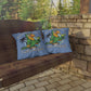 Two pillows with parrot graphics and text on a wooden swing against a stone wall and greenery background.