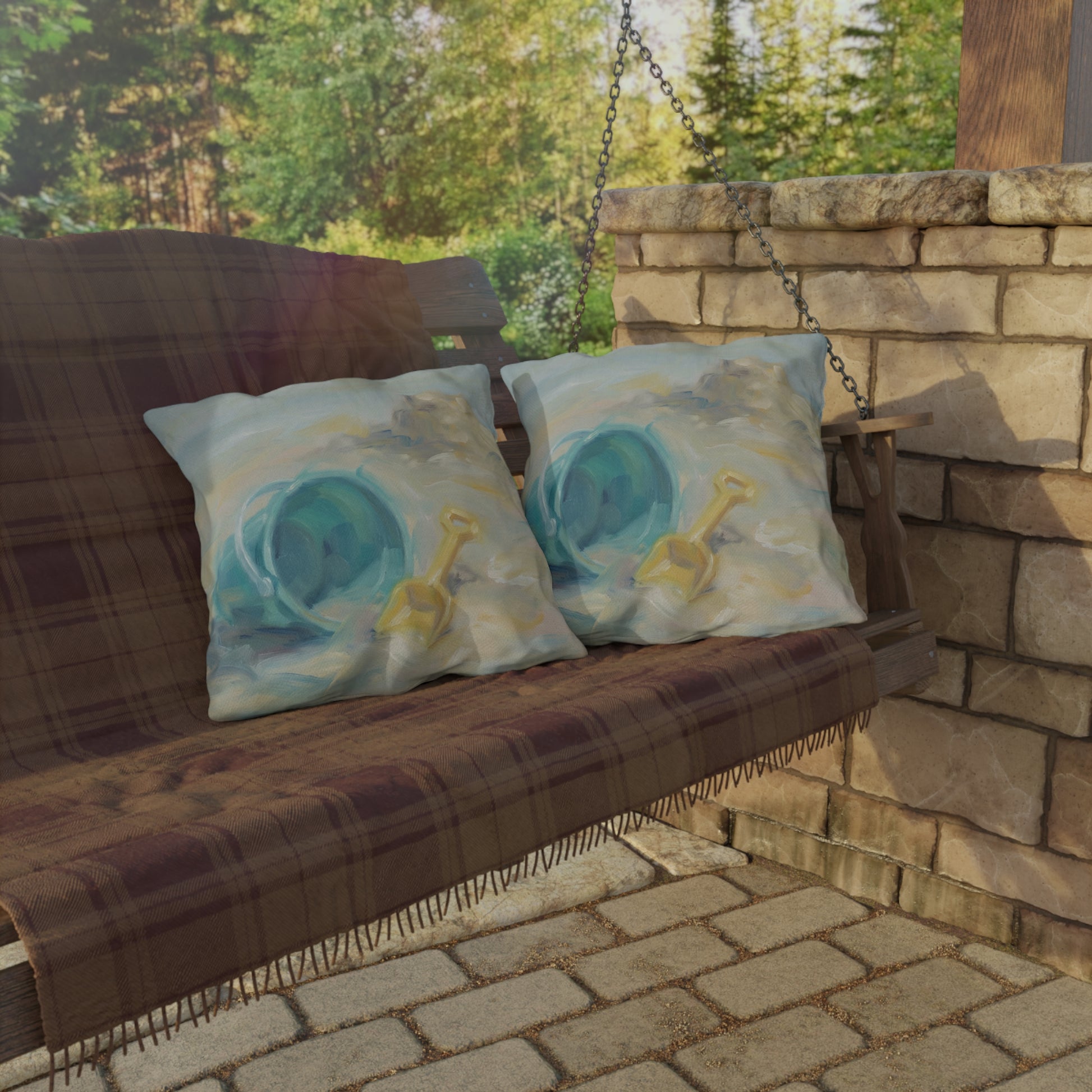 Brown wooden swing with decorative pillows on a stone patio