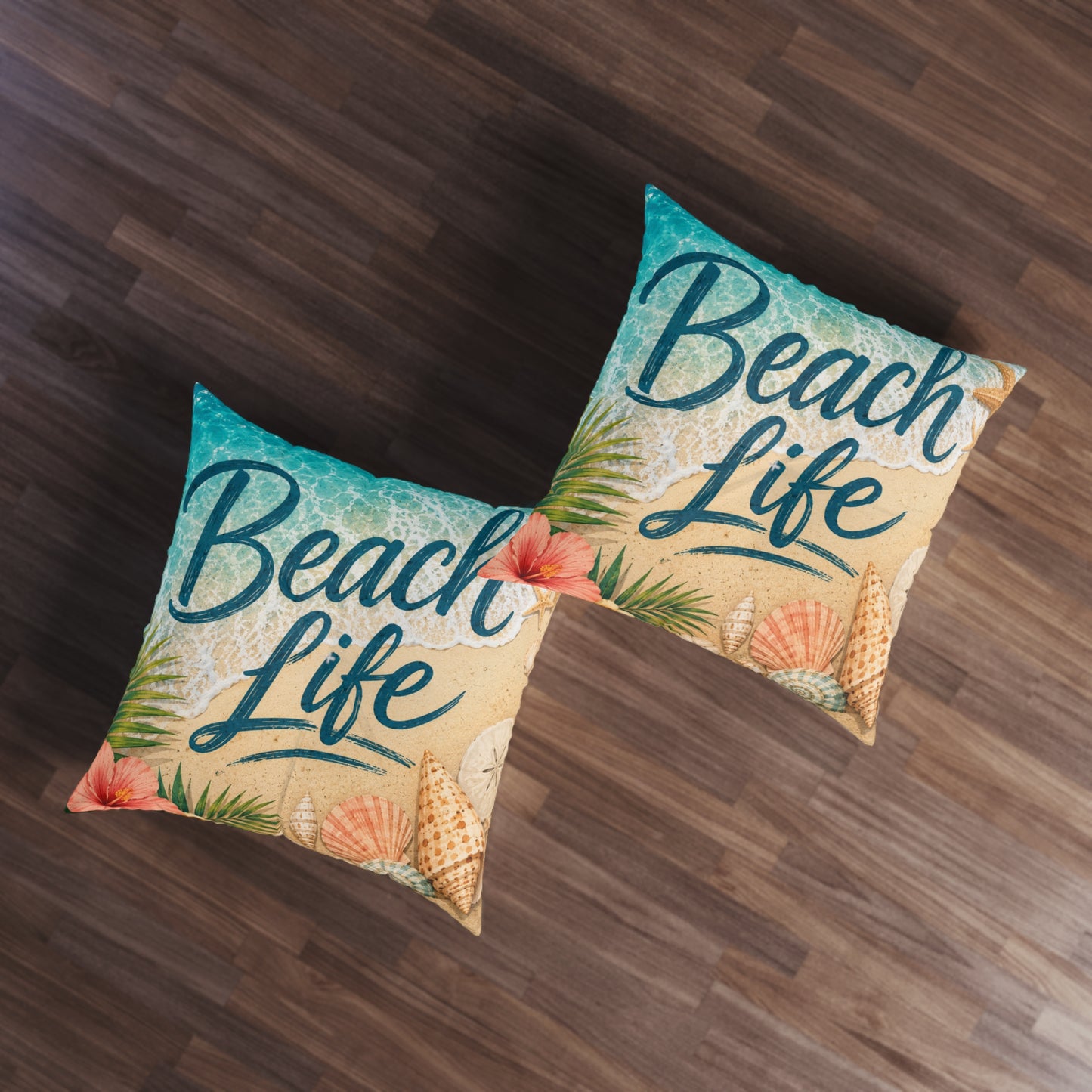 Pair of square tufted floor pillows with 'Beach Life' beach print in beige and teal.