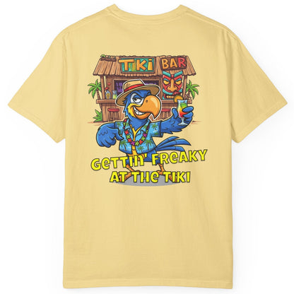 Yellow t-shirt with a colorful graphic of a parrot and tiki bar on the back, on a white background.