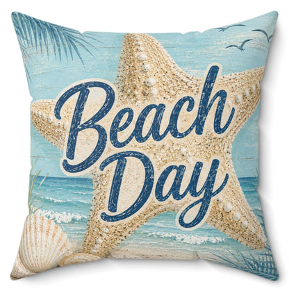 A square decorative throw pillow featuring a beach-themed print with a large starfish, seashells, palm leaves, and the words 'Beach Day' in navy script over a light blue ocean background.