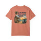 Peach-colored t-shirt with beach graphic and text on a white background