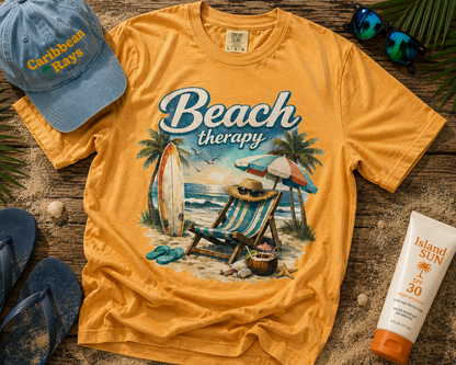Yellow t-shirt with 'Beach Therapy' design, blue cap, flip-flops, and sunscreen on a wooden surface.