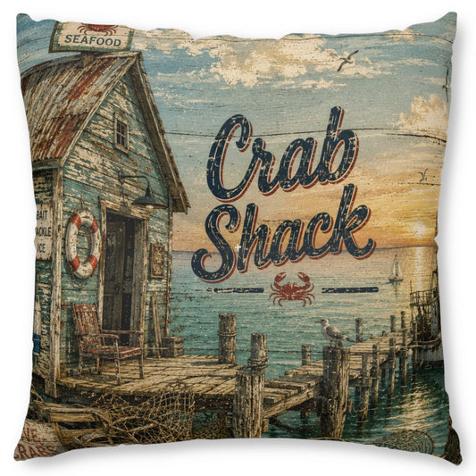 A square decorative throw pillow featuring a vintage-style printed illustration of a crab shack by the water, with the words “Crab Shack” and a small crab graphic on the front.