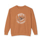 A rust-orange crewneck sweatshirt featuring a circular graphic on the chest with the words 'PUTT FOR DOUGH' and an illustration of a golf putt.