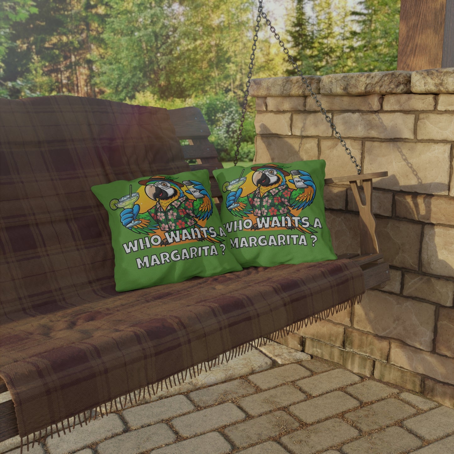 Two green pillows with a colorful design and text on a wooden swing outdoors.
