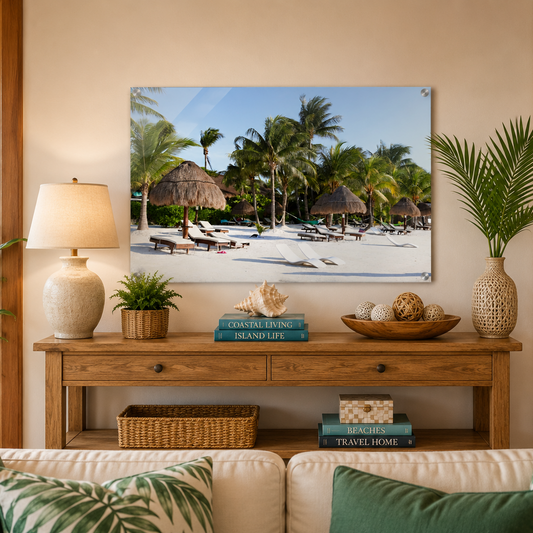 Living room with a wooden console table, lamp, books, and decorative items against a beach scene wall art.