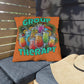 Decorative pillow with 'Group Therapy' and cocktail design on a chair outdoors.
