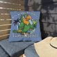 Blue pillow with a parrot graphic and text on a wooden bench