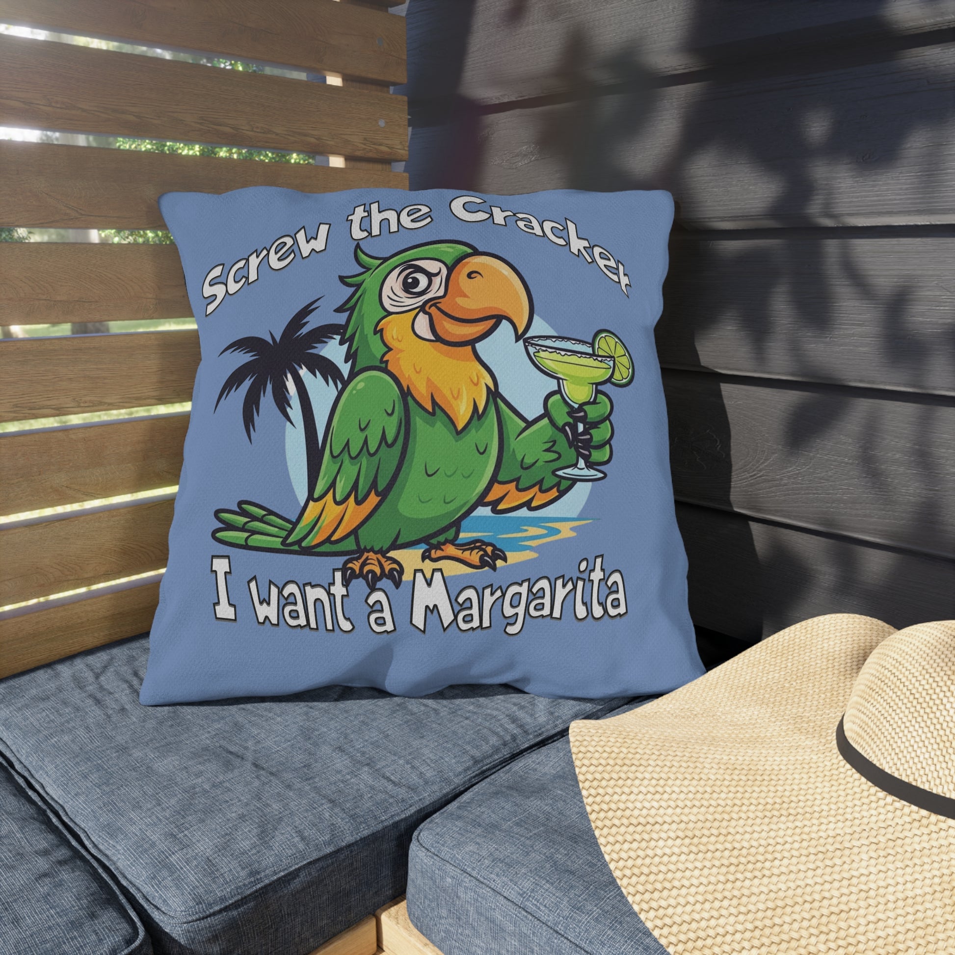 Blue pillow with a parrot graphic and text on a wooden bench