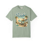 Sage green t-shirt with 'Beach Therapy' graphic design featuring a beach scene.