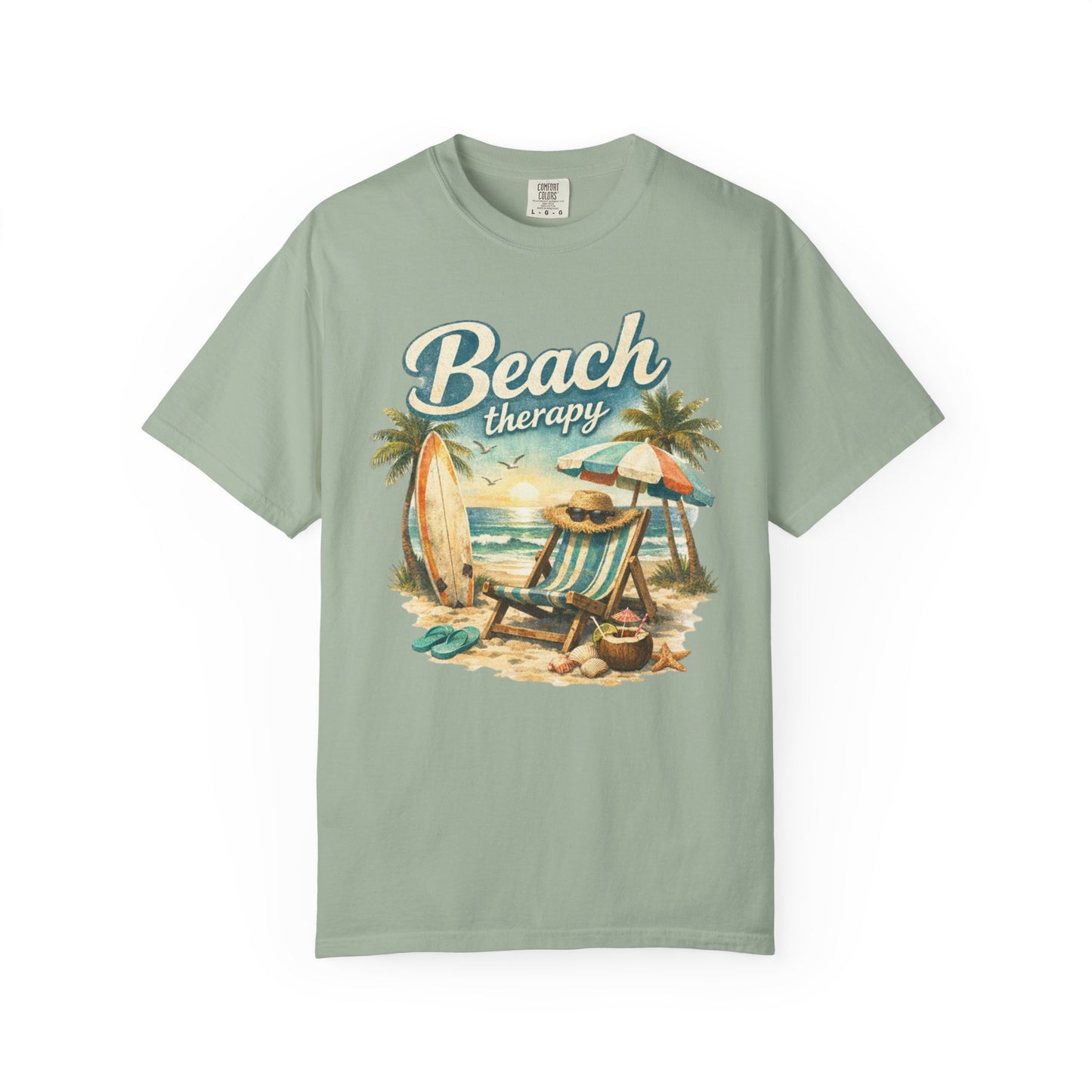 Sage green t-shirt with 'Beach Therapy' graphic design featuring a beach scene.