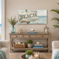 Living room with a console table, decor items, and a 'BEACH' sign painting.