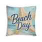 Square tufted floor pillow with 'Beach Day' script, light blue beach and starfish design.