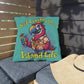 Decorative pillow with a parrot design and 'Just Living the Island Life' text on a wooden bench.