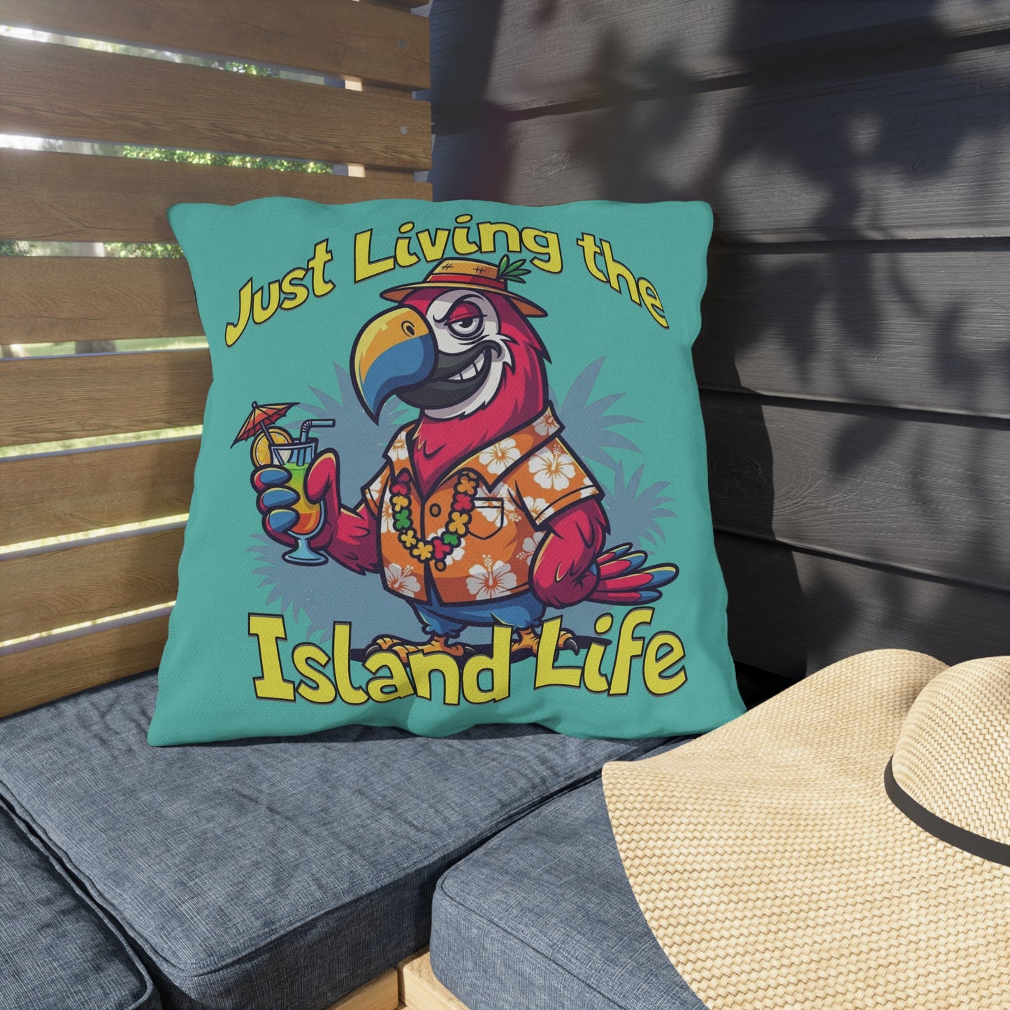 Decorative pillow with a parrot design and 'Just Living the Island Life' text on a wooden bench.
