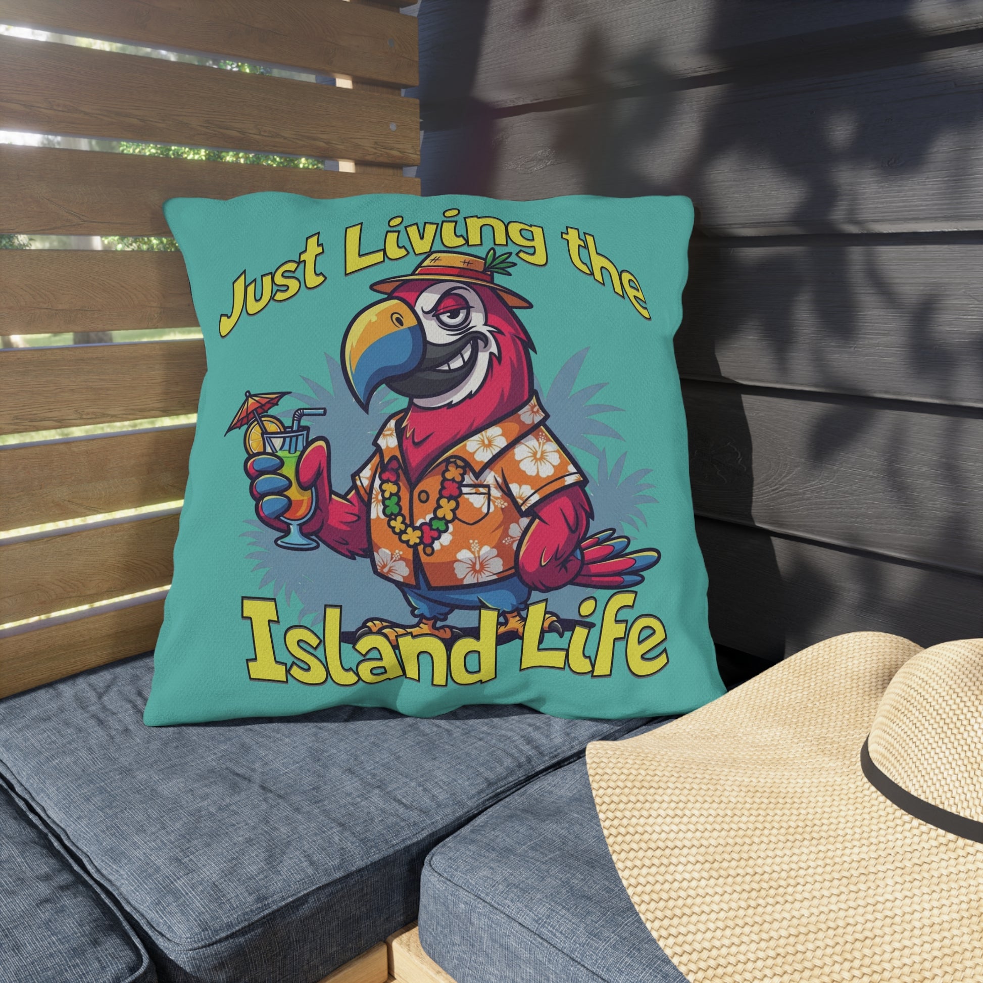 Decorative pillow with a parrot design and 'Just Living the Island Life' text on a wooden bench.