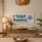 Dining room with a 'Conch Republic' sign on the wall, wooden table, and chairs.