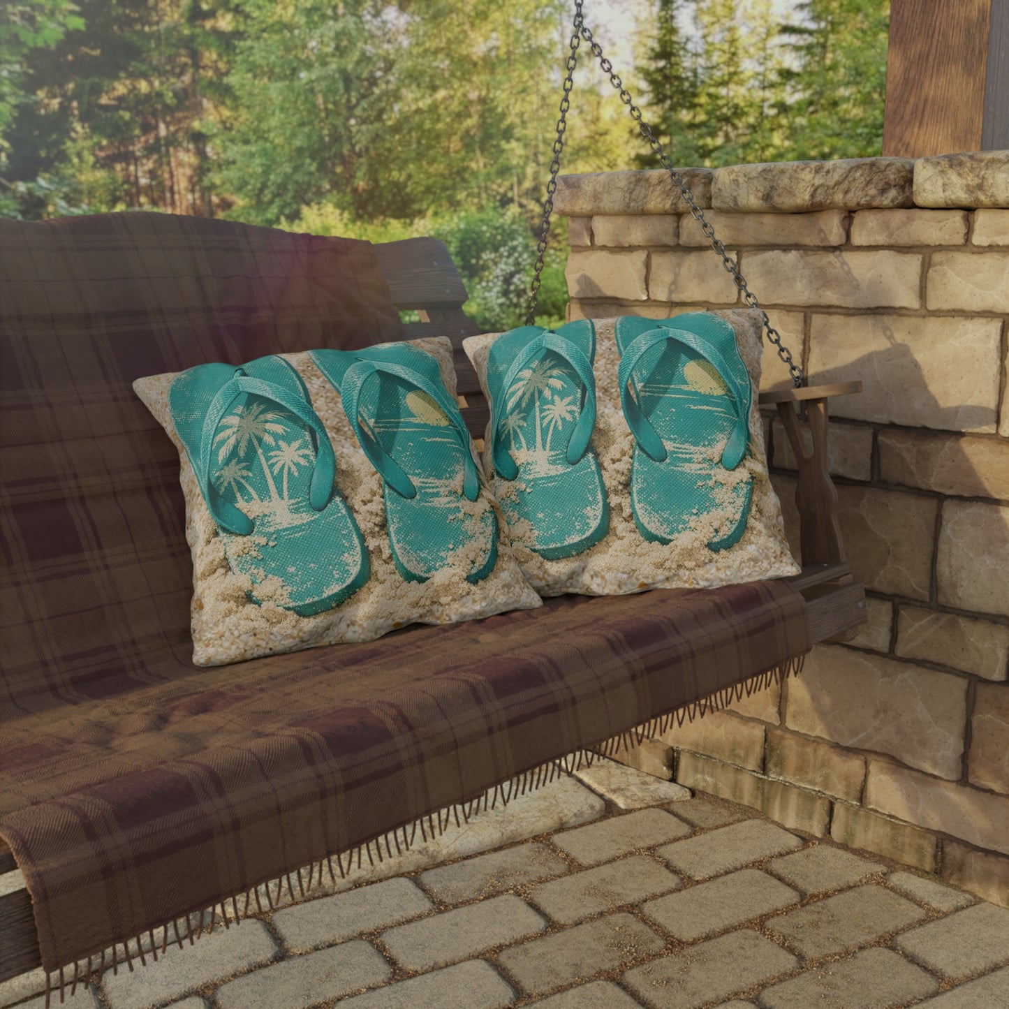 Porch swing with flip-flop design pillows against a stone wall and greenery background