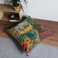 Square tufted floor pillow with Key West city signage and tropical floral print in teal and orange.