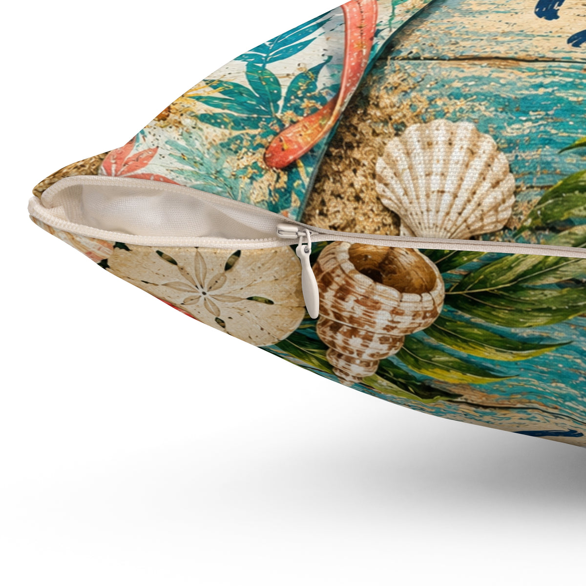 Square tropical pillow with zipper opening; seashell accents on teal and beige beach print